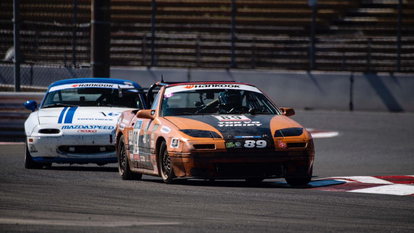 #89 leading a Miata past the PIR grandstands